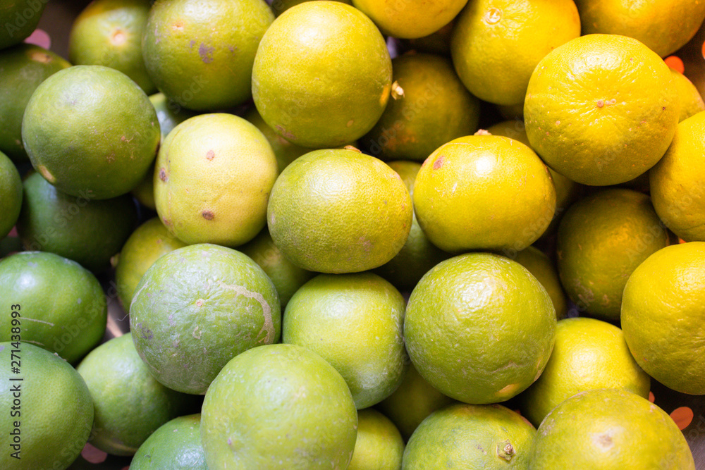 Green lemon lime or Thailand lemons on metal basket with orange light effect. Abstract of sweet, sour flavor and Thirsty.