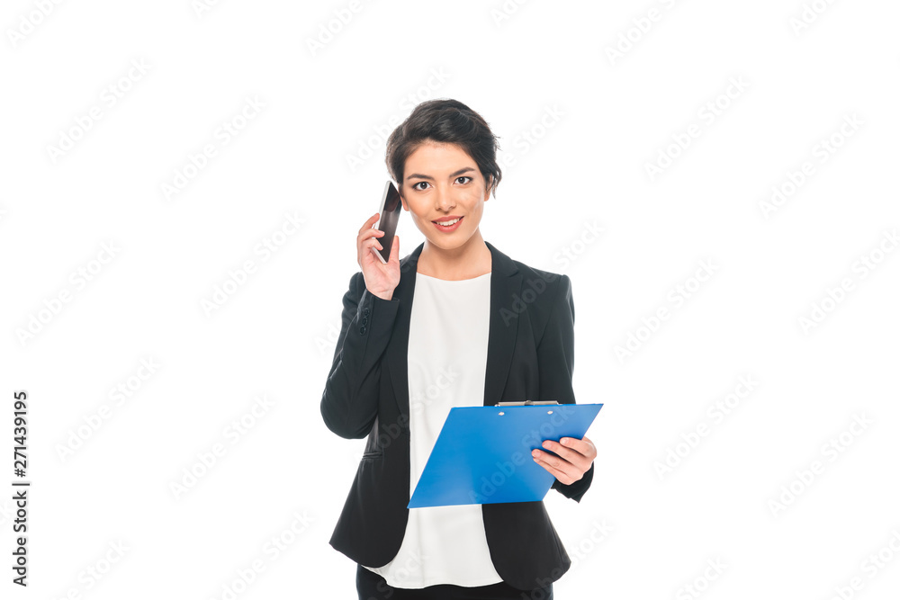 attractive mixed race businesswoman talking on smartphone while holding clipboard and looking at camera isolated on white attractive mixed race businesswoman talking on smartphone while holding clipboard and looking at camera isolated on white