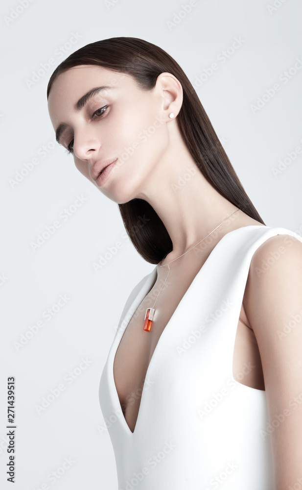 Fototapeta premium Young woman with stylish necklace looking away