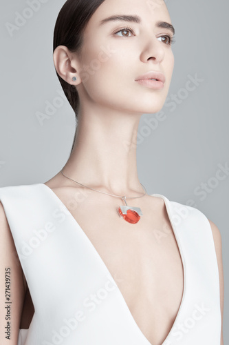 Young female with stylish necklace looking away