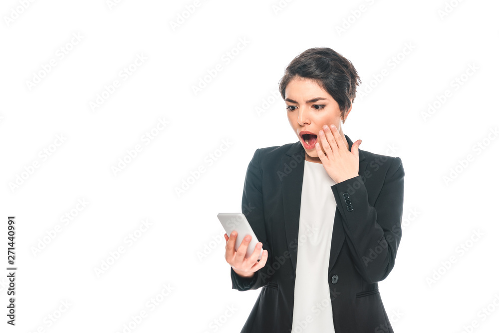 surprised mixed race businesswoman using smartphone and holding hand near face isolated on white surprised mixed race businesswoman using smartphone and holding hand near face isolated on white