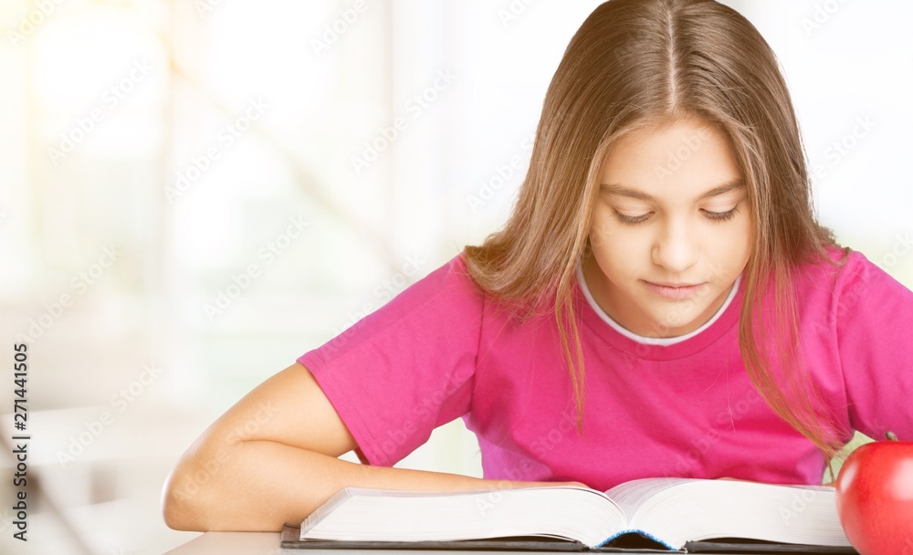 Little student girl studying on background Little student girl studying on background