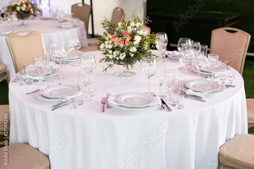 Serving a round table in the restaurant for several people. Selective focus.