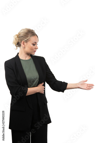 friendly young woman pointing to his side and looking into the camera. isolated on white background