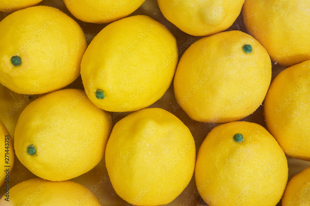 Close Up Of Plastic Yellow Lemons, Laying In Several Rows Close Up Of Plastic Yellow Lemons, Laying In Several Rows