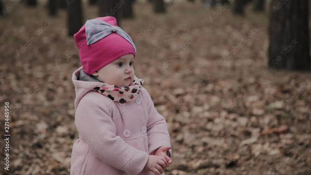 Beautiful little girl walks alone in the park. Beautiful little girl walks alone in the park.