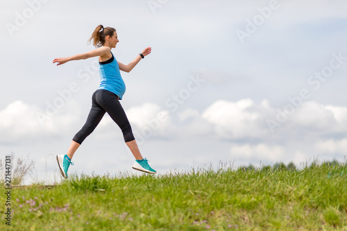 Running during pregnancy, pregnant woman working out outdoor © leszekglasner