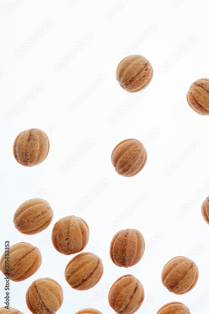 Falling homemade cookies walnuts on a white background. Falling homemade cookies walnuts on a white background.