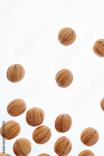 Falling homemade cookies walnuts on a white background.