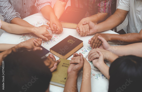 Christian worship praying to the holy scripture. they pray hands Bible in church for the faith and spiritual concept of religion.
