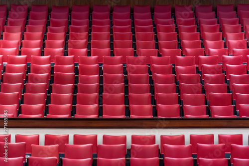 Empty theater auditorium with rows of the red seats