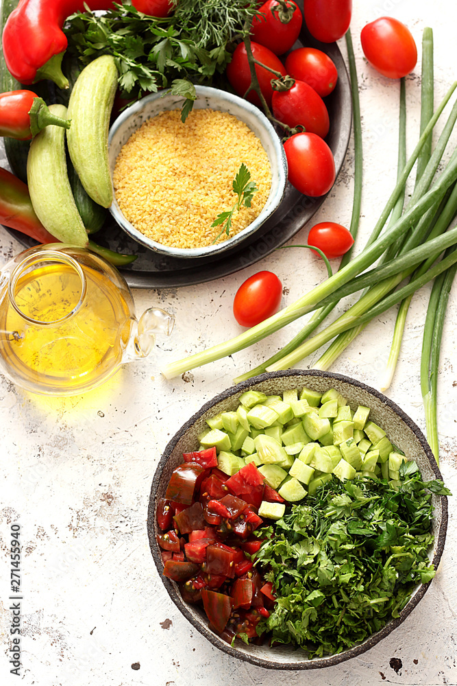 Fresh vegan Tabbouleh salad made of tomato,cucumber, parsley, onion and bulgur in bowl Fresh vegan Tabbouleh salad made of tomato,cucumber, parsley, onion and bulgur in bowl