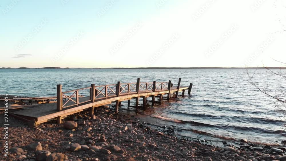 Aerial, drone shot, over a wooden pier,, at Vuoniemi ness, at lake Saimaa, on a sunny, spring evening, in North Karelia, Finland Aerial, drone shot, over a wooden pier,, at Vuoniemi ness, at lake Saimaa, on a sunny, spring evening, in North Karelia, Finland