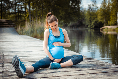 Pregnant woman exercising outdoor and resting © leszekglasner