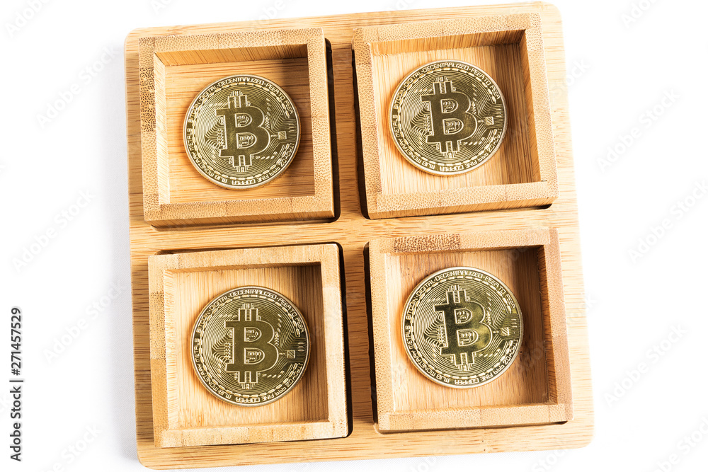 several bitcoin gold coins inside some wooden bowls