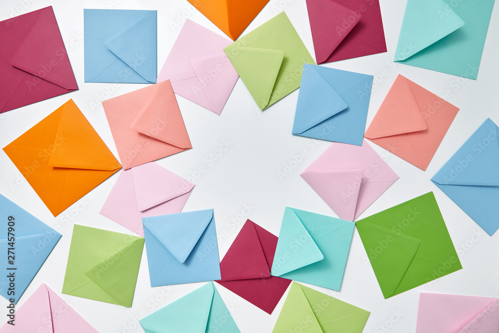 Colorful frame from empty handmade envelopes on a light background. Colorful frame from empty handmade envelopes on a light background.