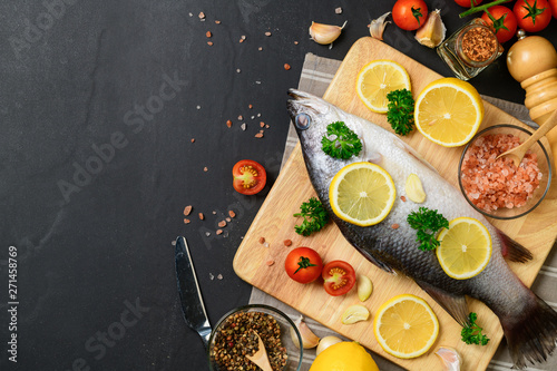 Fresh fish seabass and ingredients for cooking.