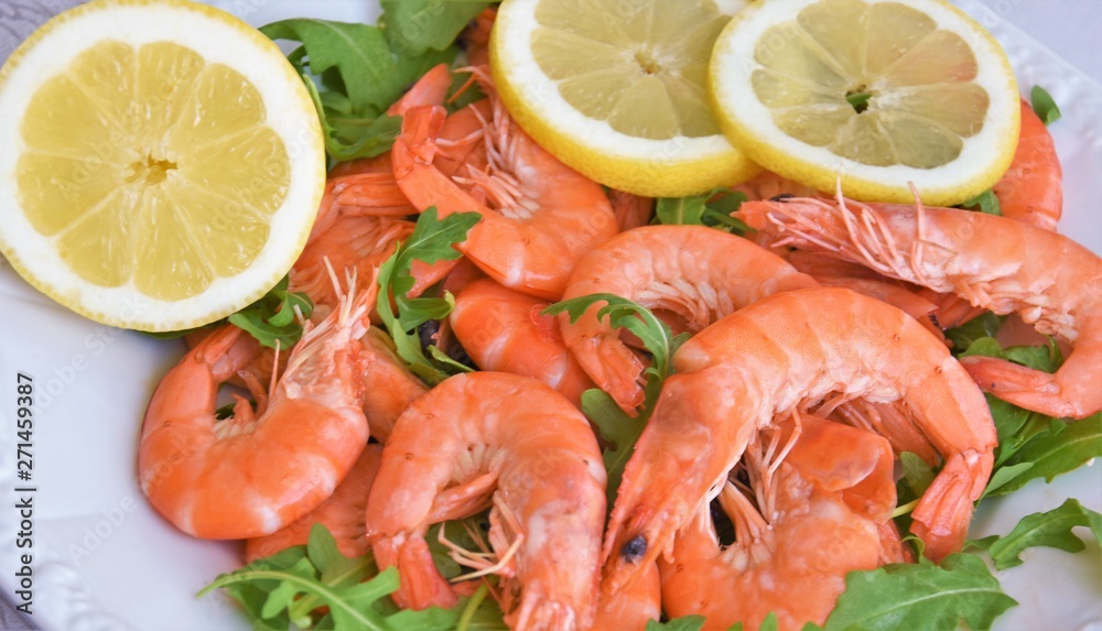 large red shrimps, arugula leaves and lemon wedges large red shrimps, arugula leaves and lemon wedges