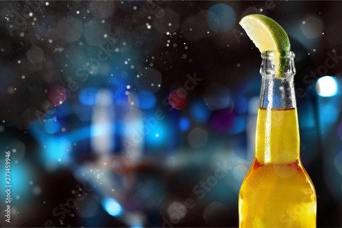 Cold beer with lime on background photo