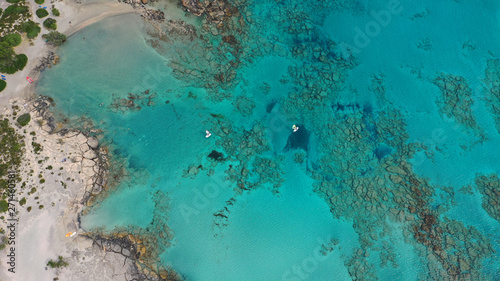 Aerial top view photo of men practising wind surfing in exotic paradise open ocean bay with crystal clear turquoise sea © aerial-drone