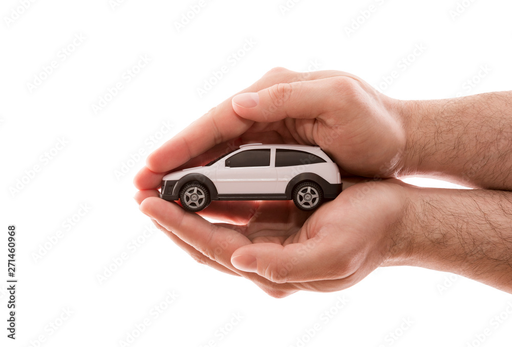 Car protection. Small white car covered by hands isolated on white background with clipping path 