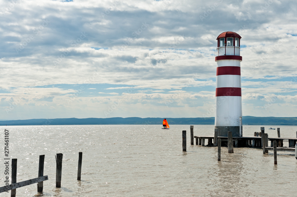 Lighthouse and a sailing boat