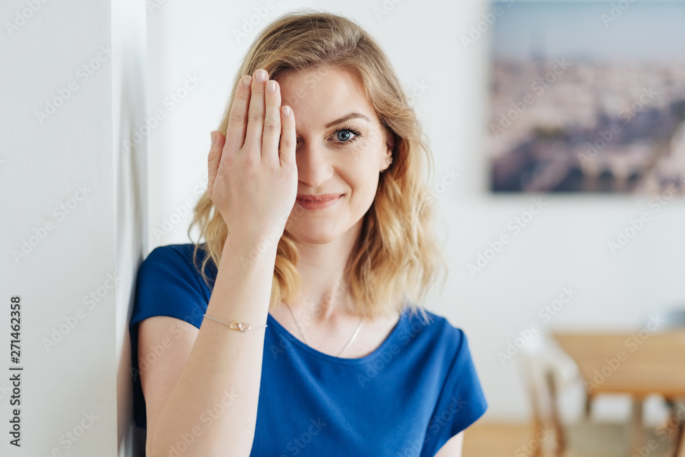 lächelnde frau hält eine hand vor ihr auge lächelnde frau hält eine hand vor ihr auge