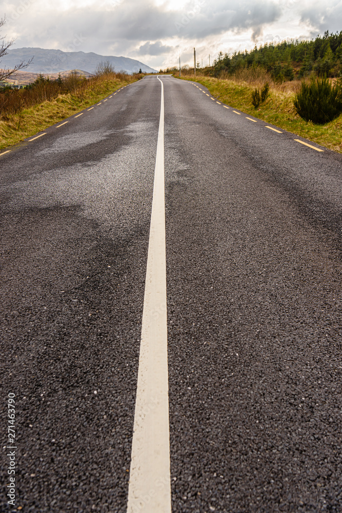 Solid white line down the middle of a rural road in County Donegal, Ireland