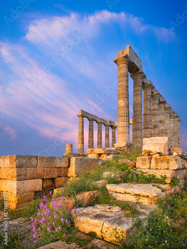 Evening light on stones and columns of temple of Poseidon in Greece
