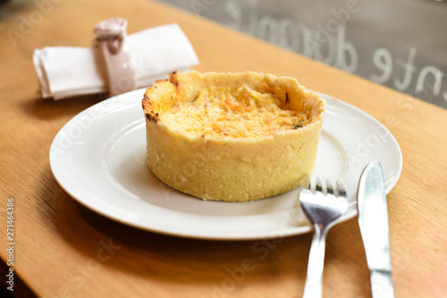 chicken quiche with rolled napkin and tableware