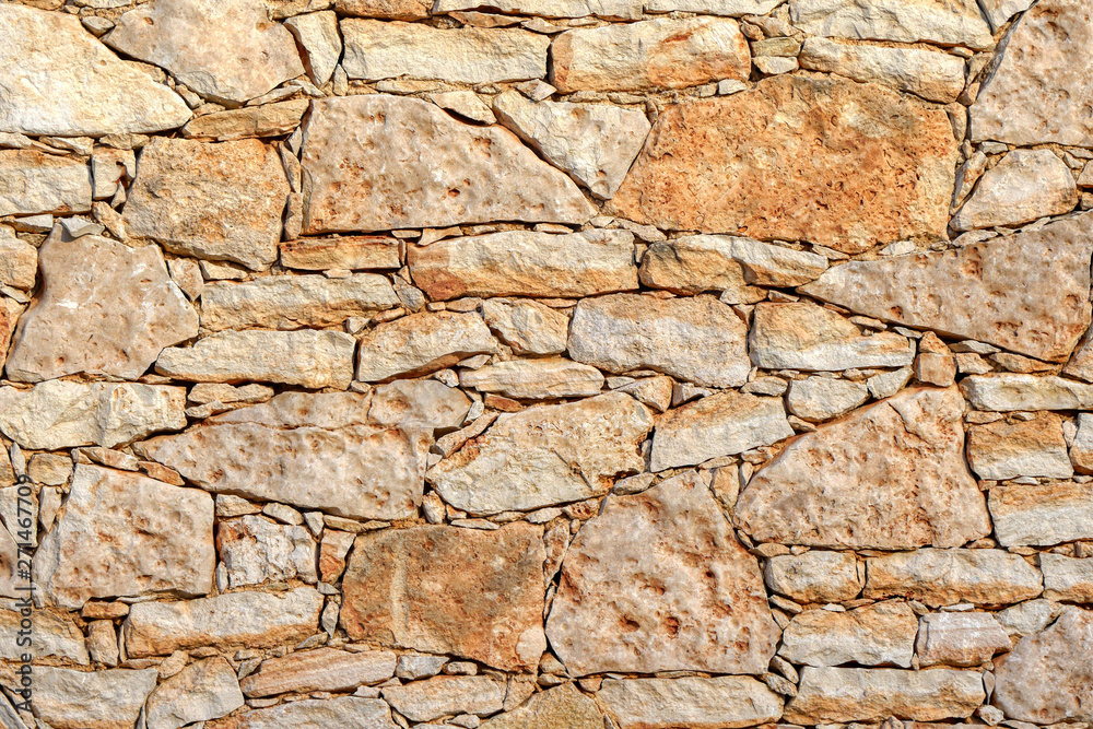 Old wall made of large and small stones Old wall made of large and small stones