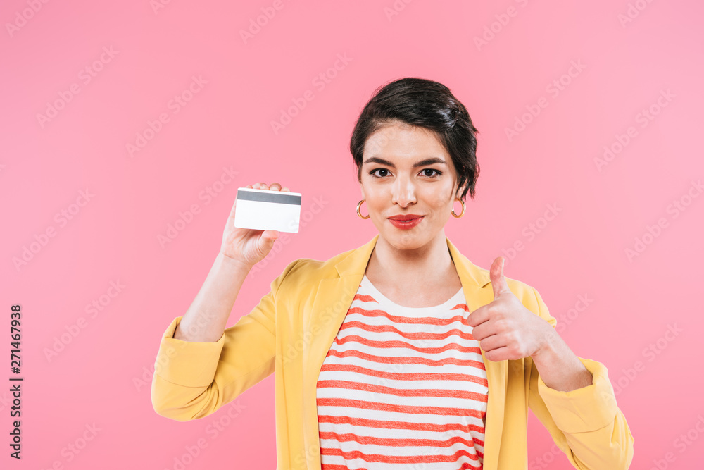 beautiful mixed race woman holding credit card and showing thumb up isolated on pink beautiful mixed race woman holding credit card and showing thumb up isolated on pink