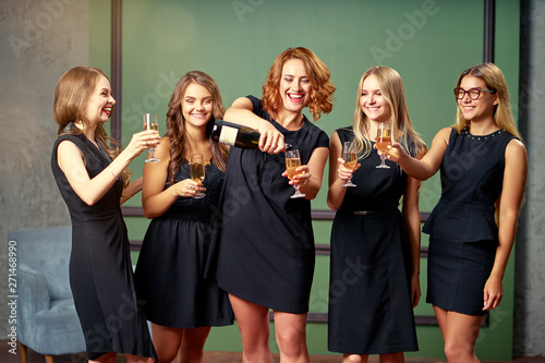 Party and celebration. Group of happy smiling young women drinking champagne having fun together.