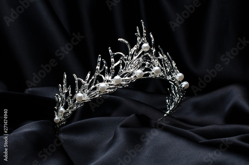 tiara with pearls isolated on a black silk