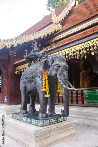 Intricate and detailed elephant statue adorned with beautiful flower garlands in Doi Suthep temple, in Thailand. © Ana Fidalgo