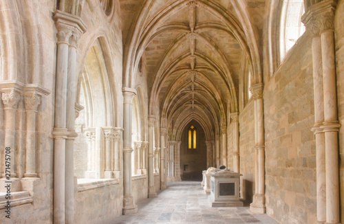 The beautiful  sunlit cloister walkway of Cathedral of Evora in broad daylight. Gothic architecture in Portugal.
