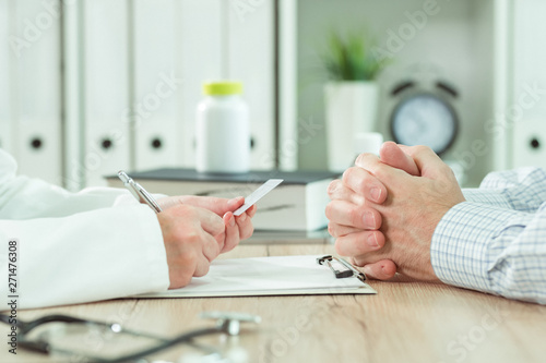 Doctor taking medical insurance card from patient