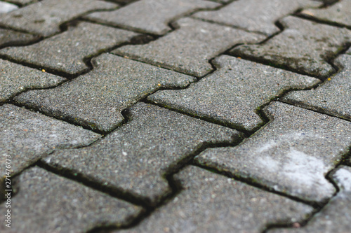 Perspective view of grey cement pavement blocks – Hard and rough material used for the construction of streets and sidewalks in the city – Abstract grunge background