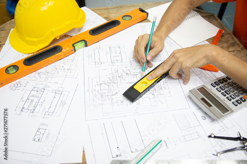 Architect Designing in blueprint at Construction Site With drawing equipment.concept