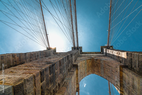 Brooklyn Bridge, New York City. Architectural Close up  Detail, An Iconic Steel Cables against Bright Sun and Blue Sky