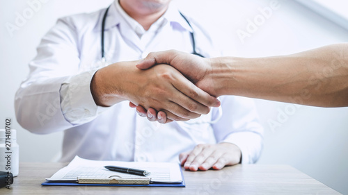 Doctor having shaking hands to congrats with patient after recommend treatment while discussing explaining his symptoms and counsel diagnosis health, healthcare and assistance concept