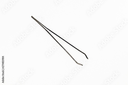 metal tweezers on white background