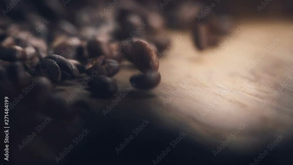 Roasting brown Coffee Beans with steam. tracking shot, close up - super slow motion. beans falling on wooden table Roasting brown Coffee Beans with steam. tracking shot, close up - super slow motion. beans falling on wooden table