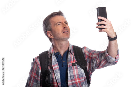 Tourist or traveling hiker unable to get cellphone reception or network.  The man can't make a call or get a rideshare because he has no service or internet. Isolated on a white background. photo