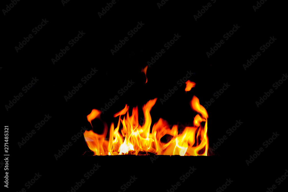 Fire flame isolated on black background. Real tongues of flame background from the fireplace Fire flame isolated on black background. Real tongues of flame background from the fireplace