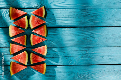 Fresh tasty watermelon on blue board and free space for your decoration. 