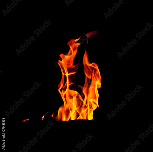 Fire flame isolated on black background. Real tongues of flame background from the fireplace