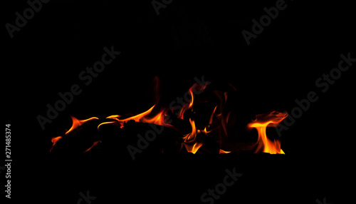 Fire flame isolated on black background. Real tongues of flame background from the fireplace