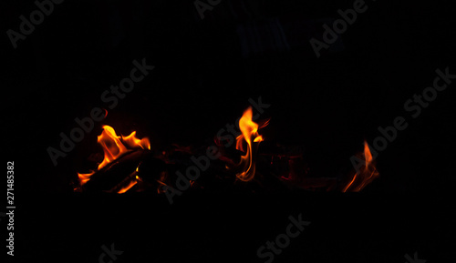 Fire flame isolated on black background. Real tongues of flame background from the fireplace