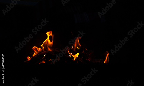 Fire flame isolated on black background. Real tongues of flame background from the fireplace © Aliaksei